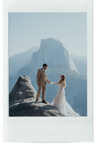 groom dips bride while they kiss standing on a rock cliff with el  capitan in the background there is a ray of orange sunlight hitting the rock behind them and the photo is in a polaroid frame