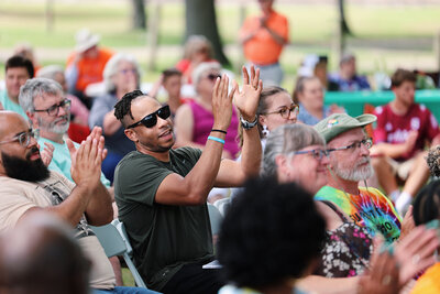 A clapping crowd of participants at a community event