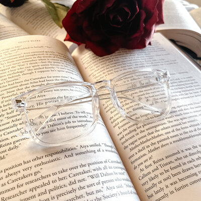 Open book with rose and glasses