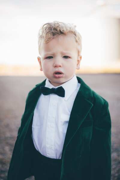A little boy in a green tuxedo captured by Shreveport family portrait photographer Britt Elizabeth.