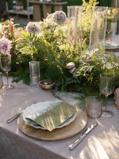 Beautiful shot of a tablescape from above with our chartreuse dinner plates, and our clear white rim chargers, and our glassware. 
