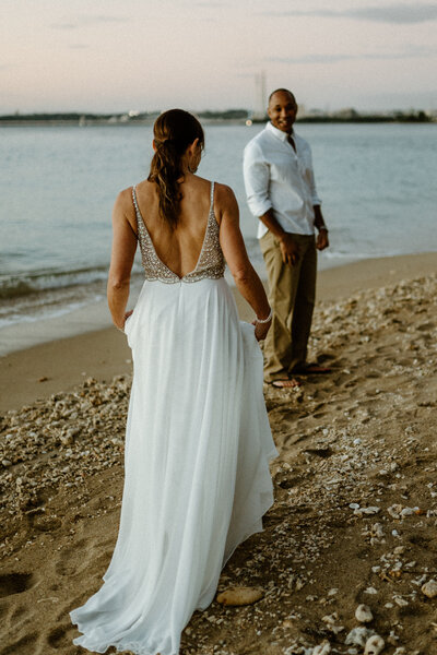 first look of L walking up to R for their sunrise wedding