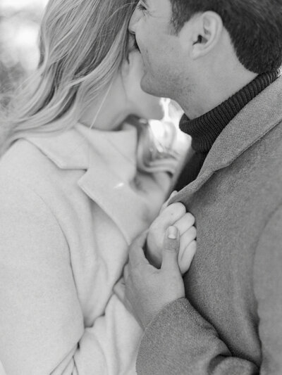 Groom whispering in bride's ear during engagement photos at Alms Park in Cincinnati, Ohio