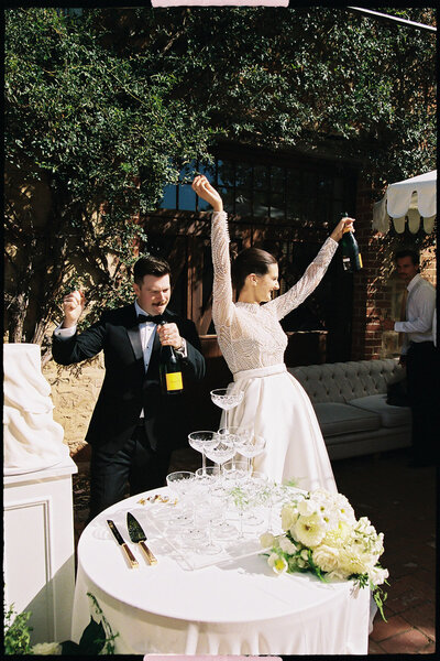 bride poses with wine glass on wedding day in adelaide