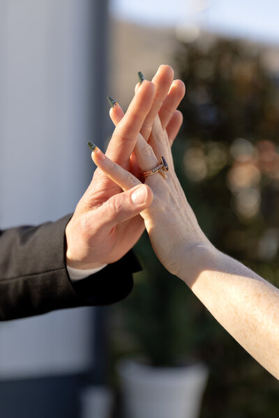 Close-up of mother and baby’s hands during family photo session in Raleigh, North Carolina, captured by Moments by Hiba.
