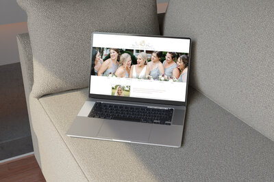 Laptop sitting on couch open to wedding florist website homescreen