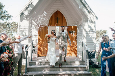 Bride and groom Lorna and Will standing at altar inside chapel at Man O’ War on Waiheke Island, photographed by Zanthe Vorsatz.