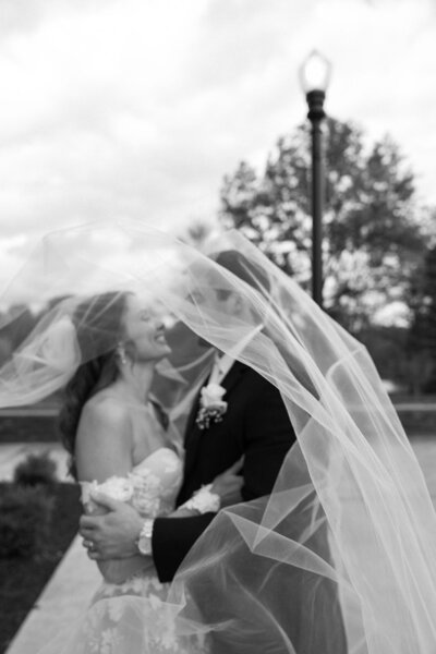 An elegant wedding couple walking together on their wedding day. Captured in Cleveland, OH by GinaMarie Presti.