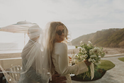 bride smiling through her veil