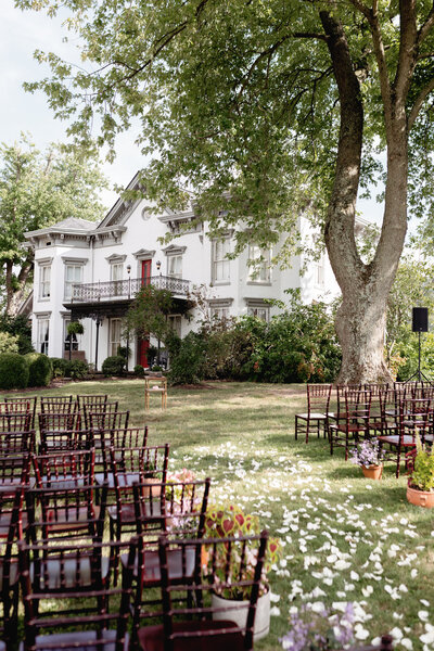 Guests seated outdoors as couple exchanges vows during a sunny Kentucky wedding