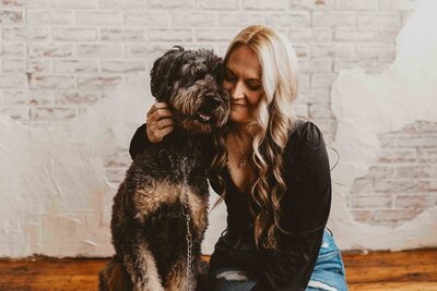 photo of a woman with her dog beside her