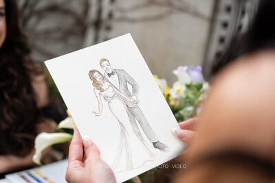 bride-holding-live-bridal-portrait-at-wedding