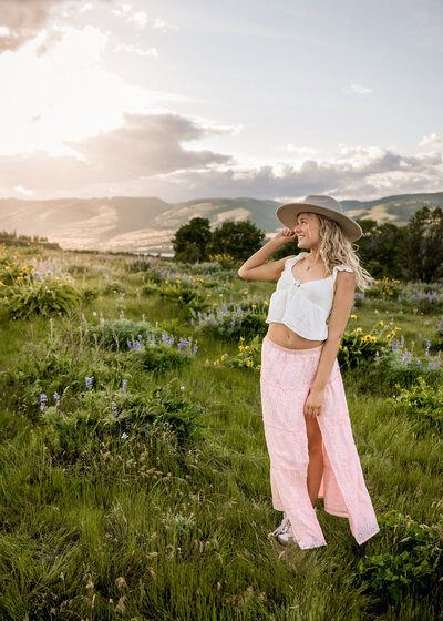 Girl standing in a field of wildflowers at Rowena Crest for senior portraits