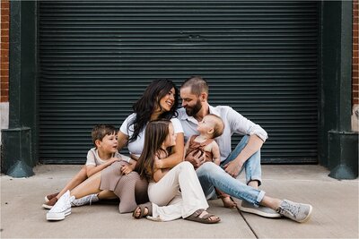 A Pittsburgh family photography session captures a family with two adults and three children sitting together and smiling.