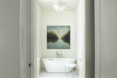 Serene white bathroom design with nature painting