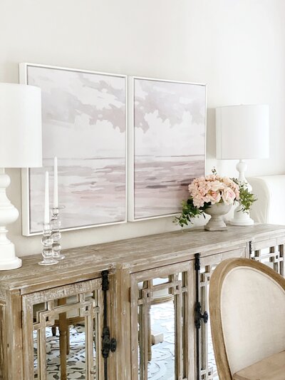 View of dining room focused on a buffet table with MTH wall art hung above