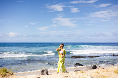 fashion model on the beach in hawaii in green pants and white bikini
