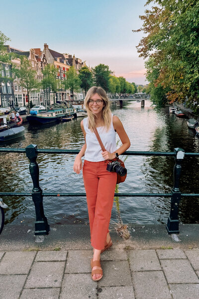 Nikki leans on a fence in Amsterdam.