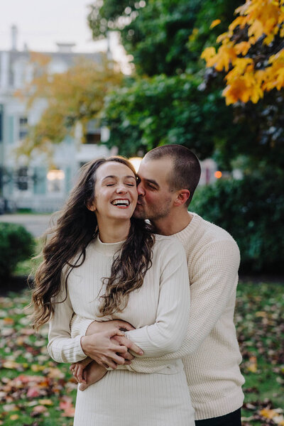 Man holding woman at finger lakes engagement session