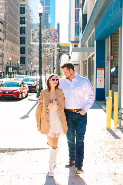 Couple walking together down a city sidewalk