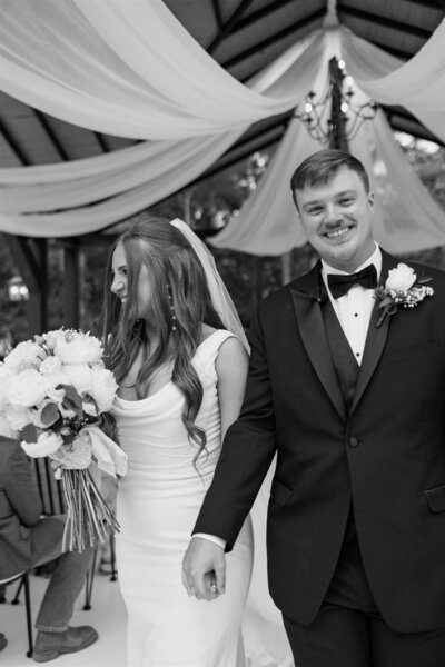 Modern Wedding at The Orchard Wedding Venue in wedding attire walking towards camera motion blur.