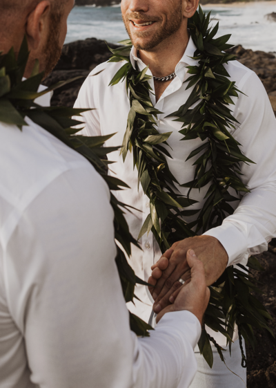 Couple holding hands with wedding ring