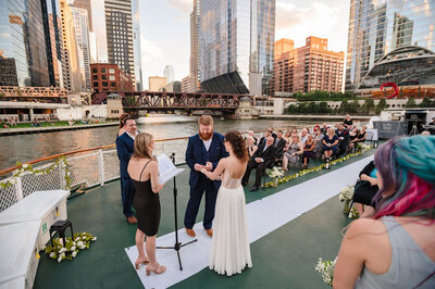 Surrounded by the chicago skyline bride and groom get married on Chicago's First Lady Cruise.
