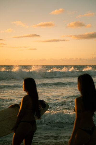 Couple plays around in the ocean in Oahu