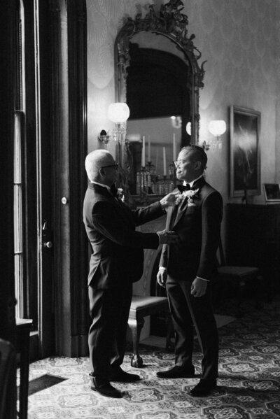 Father of the groom assisting his son with final wedding preparations before the ceremony at a Richmond, VA wedding.