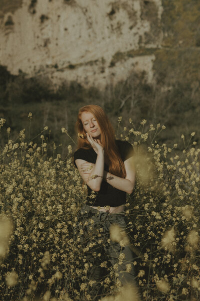 woman standing in yellow flower field in Malibu califnoria