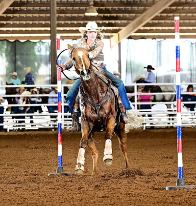 Royalty Vet customer and her pole bending horse performing.