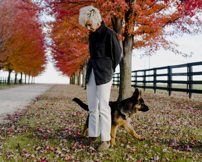 Sasha training puppy in the fall outdoors