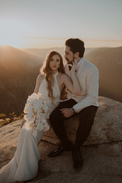 Bride and groom sit together at Taft Point