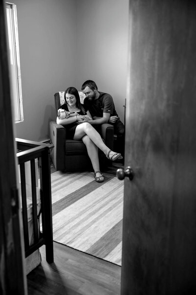 Black & White Photo of Parents starting down at newborn baby | Maine Newborn Photographer