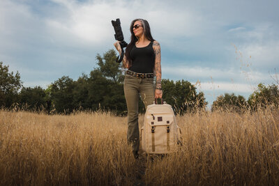 photo of ashley bird of three feathers photography standing in a field
