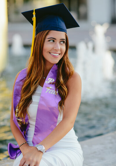 FAU Graduate posing for Graduation Portraits on campus