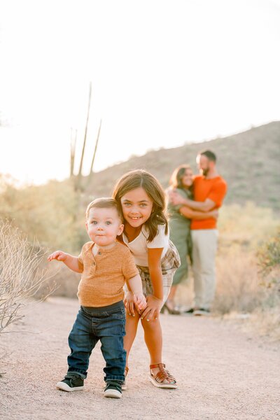 mother and father with toddler posing for family photos in carfree az