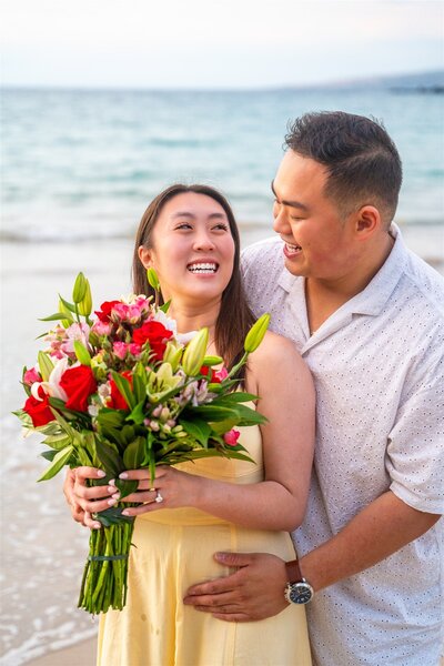 Detail photo of a couple wearing traditional Hawaiian leis during a beach proposal at ʻAnaehoʻomalu Bay in Waikoloa, photographed by Hawaii Adventure Portraits, a Big Island proposal photographer