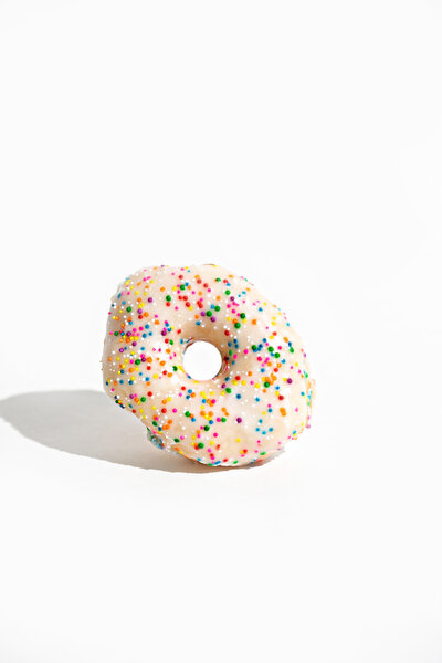 Single Sprinkle Donut on a White Background - Daylight Donuts