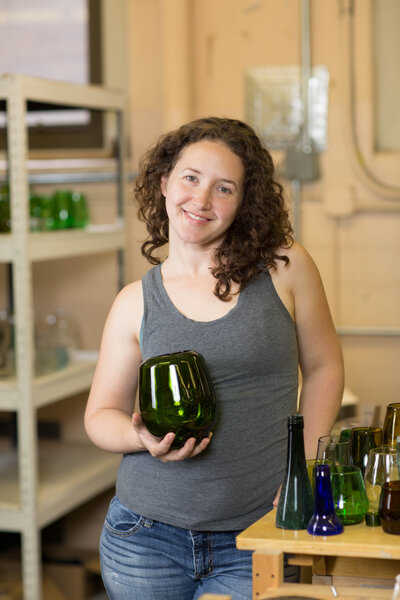 Business owner holding her product, hand blown vase