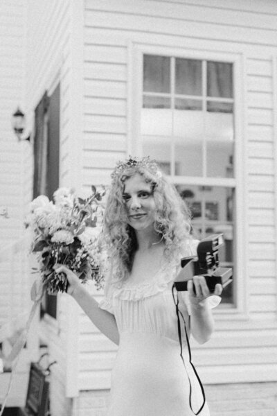 Bride posing solo in her wedding dress amidst garden greenery in Richmond.​