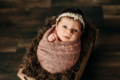 Baby girl holding heart newborn session