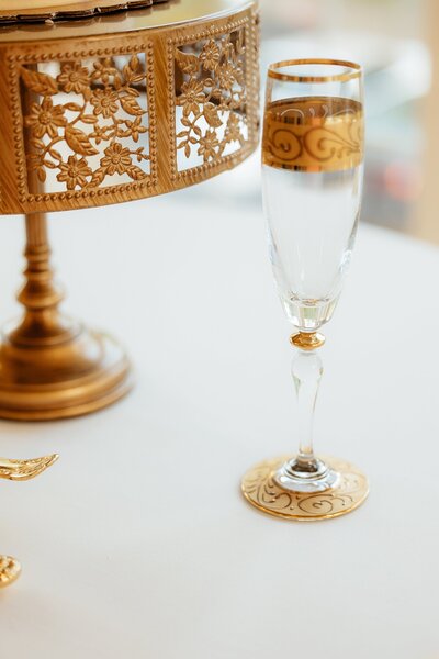 A champaign glass by the cake stand at a Rapid City Wedding.