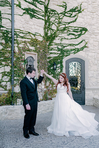 Bride and groom dancing in courtyard at Wolf Knotting Hill Place wedding in Dallas