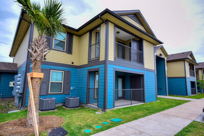 Exterior view of The Glades of Gregory Apartments in Gregory Texas highlighting the modern residential buildings managed by WLS Interests.