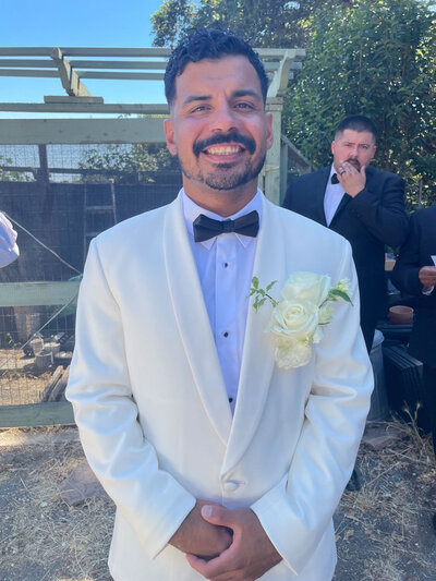 Groom in suit with the grooms men behind