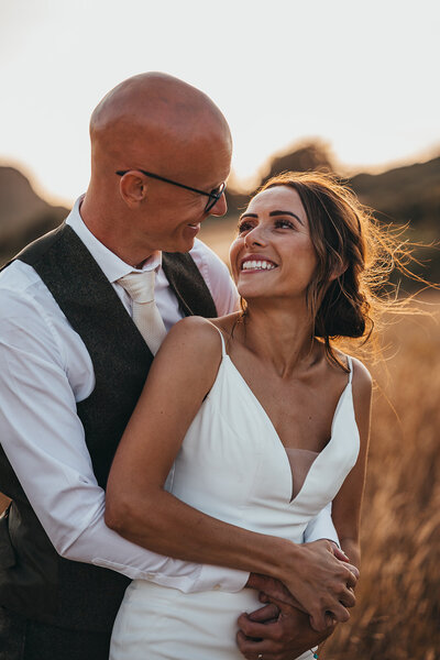 couple embrace in golden sunlight