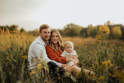 woman holding pregnant belly in field