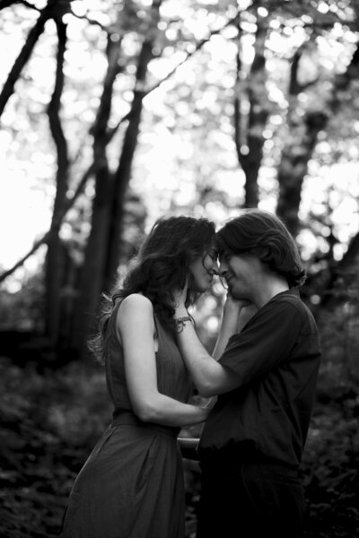Bride and groom kissing during their forest wedding ceremony near Seattle, WA