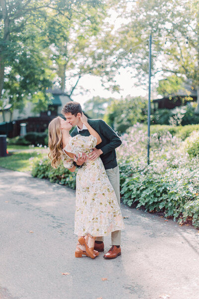 Groom dips bride and kisses her during engagement photos at The Frick in Pittsburgh 